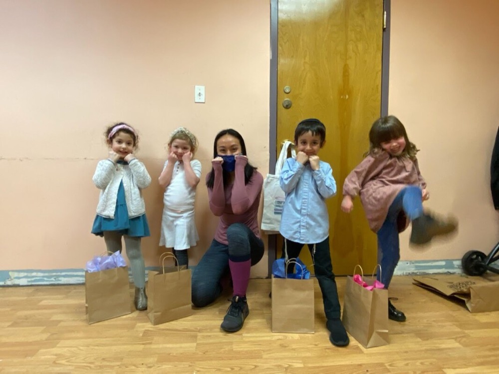 An instructor with young students after a Martial Arts class