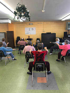 Seniors doing a chair Zumba class at JASA in Coney Island